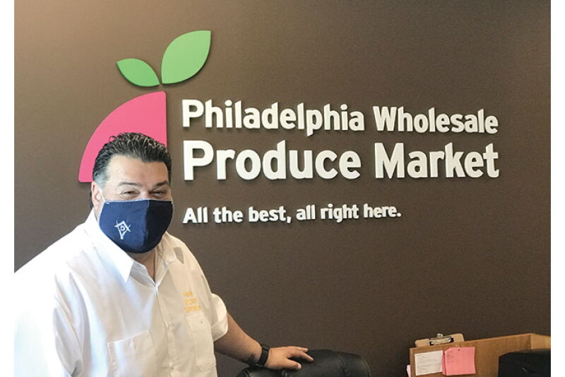 Mike Collazo, head of security at the Philadelphia Wholesale Produce Market, reminds everyone to mask up.