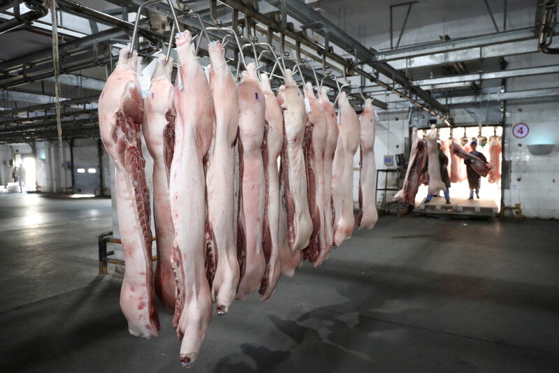 FILE PHOTO: Employees work at a pig slaughtering and pork processing plant in Huaian, Jiangsu province, China April 9, 2020. China Daily via REUTERS/File Photo