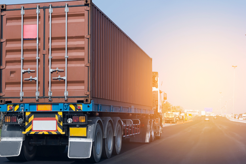 A tractor trailer truck traveling on an interstate highway