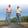 Standing over a burned windrow, Harry Stephens, left, and Robert Goodson hope the payoff is a direct assault on the mother lode source of weed seed.