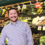 white guy with beard in front of vegetables