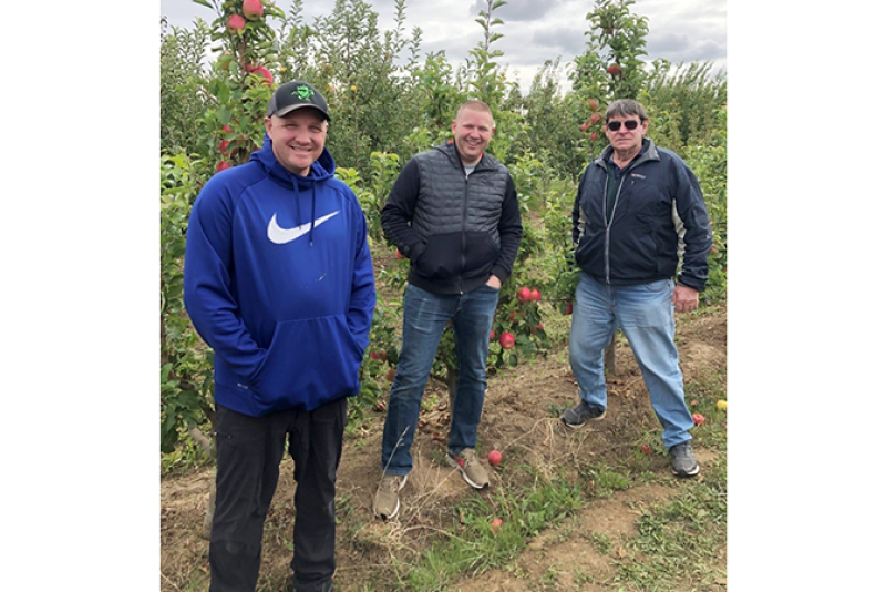 Proprietary Variety Management vice presidents Ryan Brandt and Kevin Brandt meet with PLBARB1 cultivar owner Dennis Barnsby in the Brandt’s Fruit Trees test block on Sept. 30.