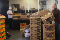 Peter Resteghini (right), buys and sells mostly berries and melons for 4M Fruit Distributors at the New England Produce Center.