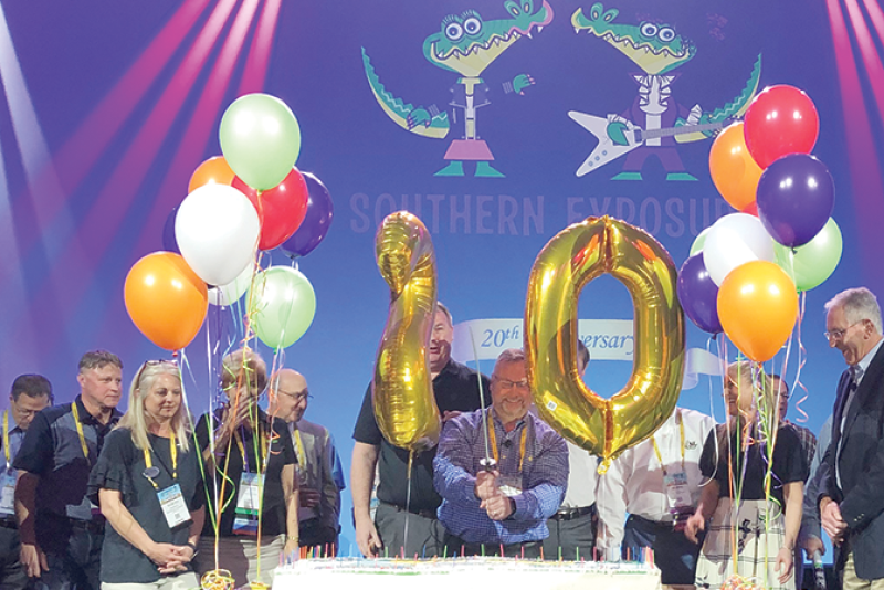 David Sherrod (center), president and CEO of the Southeast Produce Council, cuts a cake with a sword at last year’s Southern Exposure to celebrate the 20th anniversary of the show.