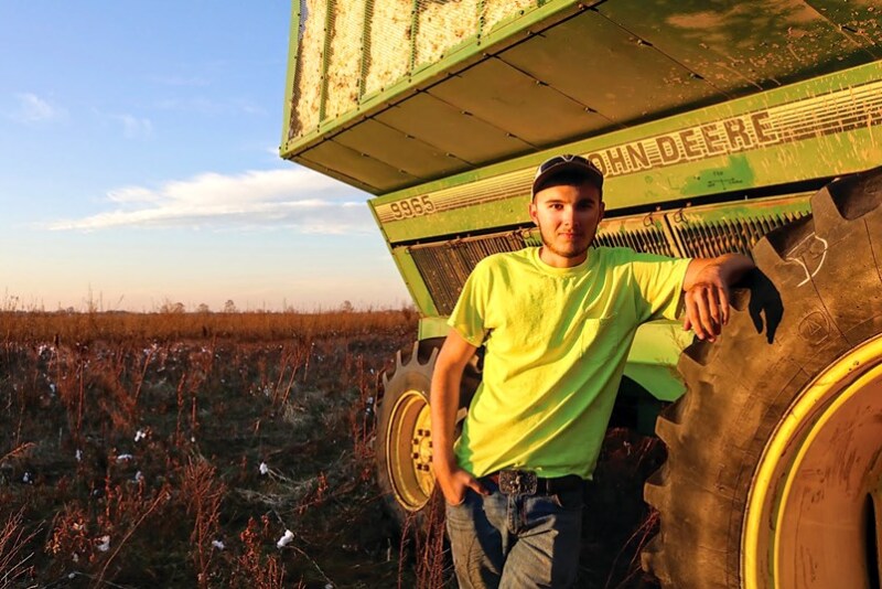 Garrett Heil next to cotton harvesting equipment