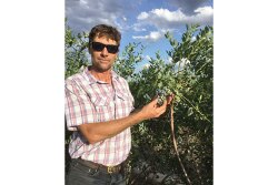Bradley O’Neal Jr. of Coosaw Farms shows off some of the company’s blueberries.