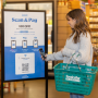woman scanning a qr code at grocery store