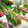 Shopper examining vegetables on a display