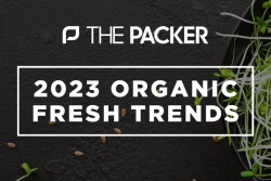 A black bowl of sprouts with overlay text - The Packer's 2023 Organic Fresh Trends