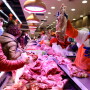 Customers wearing face masks shop at the pork counter of a supermarket following the outbreak of the novel coronavirus in Wuhan
