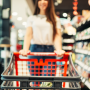 Woman pushing shopping cart in grocery store