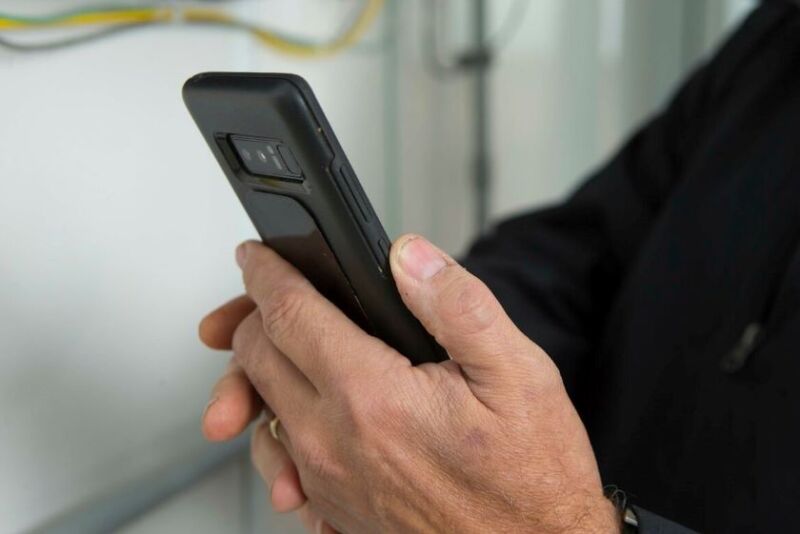 Person holding a cell phone by National Pork Board