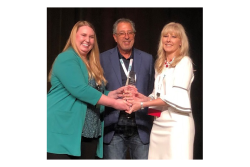 Ashley Nickle, editor of Produce Retailer and retail editor of The Packer (left) and Jimmy Bassetti, executive committee chairman for the Texas International Produce Association and president of J&D Produce Inc., Edinburg, Texas, present the Viva Fresh Healthy Living Award to  Michelle Ann Passaretti,  senior director of innovations for Geisinger’s Steele Institute of Health.