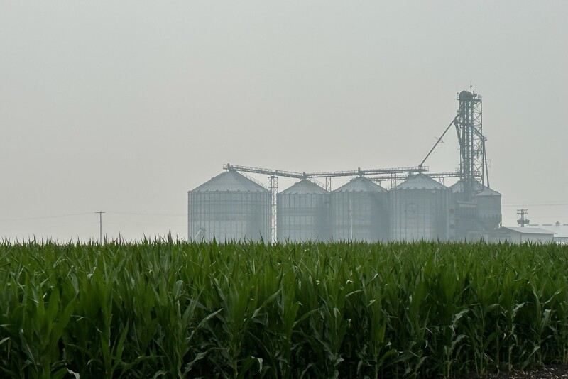 A light blanket of smoke envelops a set of grain bins on an Illinois farm on Wednesday morning.