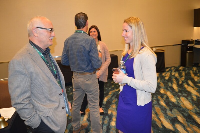Brian Zomorodi, vice president of quality and food safety for Apio Inc., Guadalupe, Calif., visits with Danielle Gilmartin, senior operations manager for New York-based HelloFresh at a reception at the 2018 freshPACKmoves conference May 22 in Monterey, Calif.