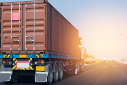 A tractor trailer truck traveling on an interstate highway