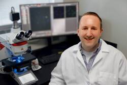 Assistant Professor Karl Kerns with THUNDER epifluorescent microscope in his lab