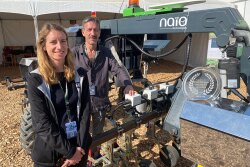 Ingrid Sarlandi and ??? of Naio Technologies stand next to Orio, a top ten product winner at the World Ag Expo this year. Orio is a straddle robot designed for row crops and beds of vegetables. 