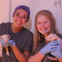  Jenna Siegel (left) and Meghan Clancy, members of the 2018 #RealPigFarming Student Social Forces team, pose with pigs and tour Brenneman Pork.