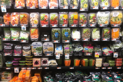 An assortment of pre-cut and packaged produce on a store's produce shelves