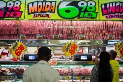 Customers buy meat from at a butchery stall inside a market in Sao Paulo, Brazil, on Saturday, March 18, 2017.