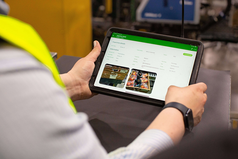 A person using a smart tablet with AgroFresh's FreshCloud digital platform