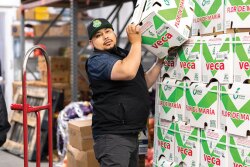Manuel Orozco, co-owner with his brother, Luis, of Arcadios Produce Inc., fills an order at the company’s facility on the San Francisco Wholesale Produce Market. A multi-year project calls for replacing each of the original four buildings on the market, says Michael Janis, general manager.