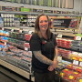 woman in front of berries at supermarket