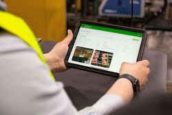 A person using a smart tablet with AgroFresh's FreshCloud digital platform