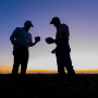 Two men representing the melon shippers standing in a field