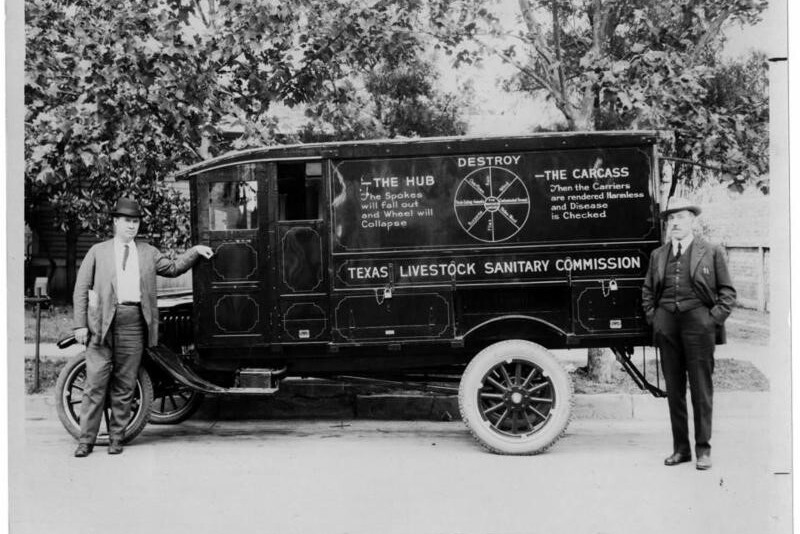 Two men stand next to the Texas Livestock Sanitary Commission van, whose purpose was to dispose of carcasses, and other materials that would be in danger of contaminating the water, wind or the ground
