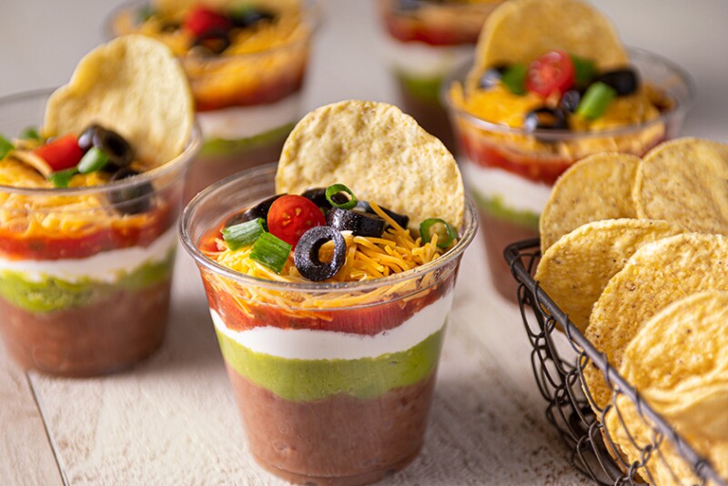 cups of salsa, queso, guacamole with tortilla chips