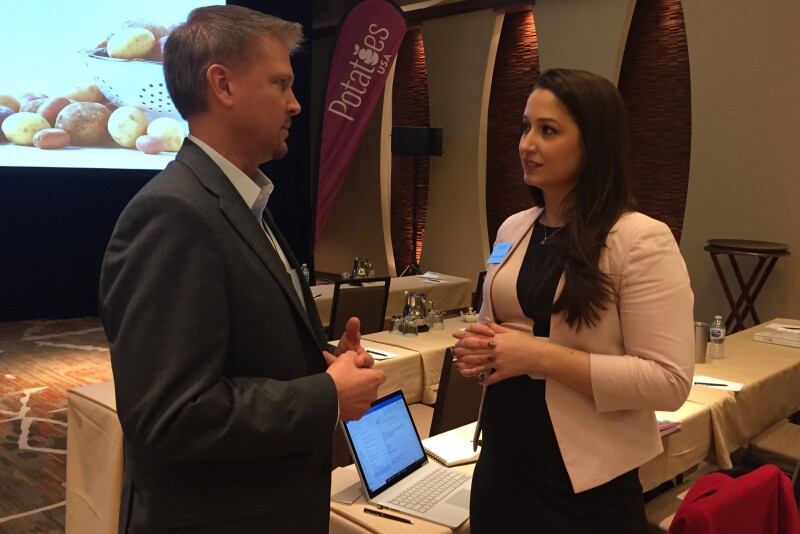 Mark Klompien, CEO of United Potato Growers of America, talks with Potatoes USA global marketing manager – school foodservice Rachael Lynch March 14 at the board’s annual meeting. 
