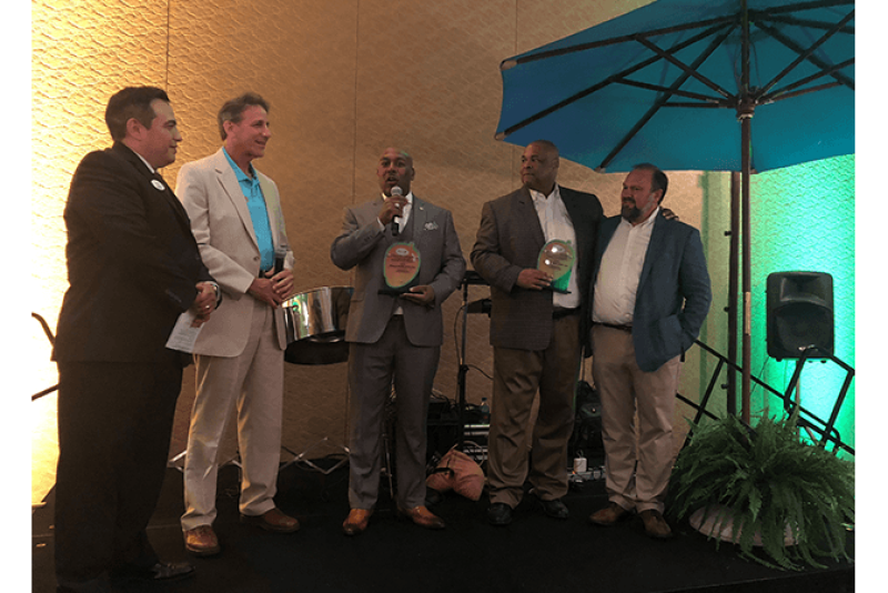 Perno W. Young III of ShopRite accepts the Mango Retailer of the Year award with his colleague Derrick S. Jenkins (second from right), who is standing with Lance Jungmeyer of the Fresh Produce Association of the Americas. The award was presented by Manuel Michel and Michael Warren of the National Mango Board. 