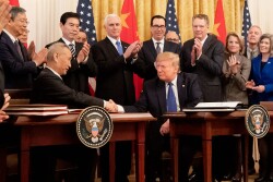 Chinese Vice Premier Liu He and President Donald Trump shake hands after signing phase one of a trade agreement.