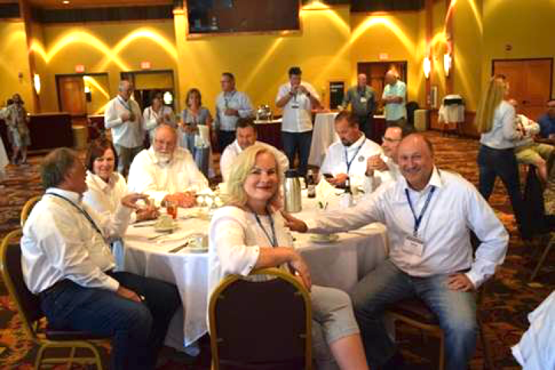 Paula Houlihan, front-center, and Wisconsin Potato & Vegetable Growers Association executive director Tamas Houlihan, right, enjoy festivities at the National Potato Council summer meeting in July in Wisconsin Dells, Wisc.