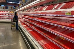 An empty grocery store meat case in March.