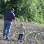 Grandpa and Grandson on the farm in a field
