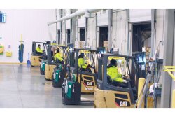 Crew members operate electric forklifts at Fresh Taste Produce Ltd., based at the Ontario Food Terminal in Toronto. The family-owned company is an importer, packer, wholesaler and distributor of a wide range of fruits and vegetables and serves all of Canada from the food terminal, says Julian Sarraino, chief operating officer.