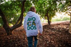 A hoodie from the Commission’s merchandise shop, photographed in a grove. 