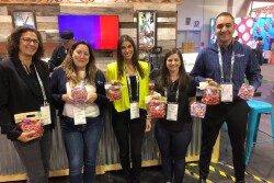 Helen Aquino, director of brand marketing and communications for Village Farms, (second from left) said the Heavenly Villagio Marzano variety was the focus of attention at the company's Produce Marketing Association Fresh Summit booth.