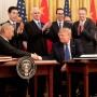 Chinese Vice Premier Liu He and President Donald Trump shake hands after signing phase one of a trade agreement.