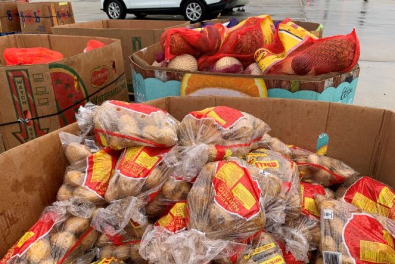 Produce shippers have been donating to excess produce to food banks as they wait for COVID-19 federal relief programs to begin. In the picture, potatoes and other produce are distributed at a Houston neighborhood.
