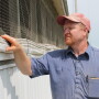 Pig Farmer Checking Barn