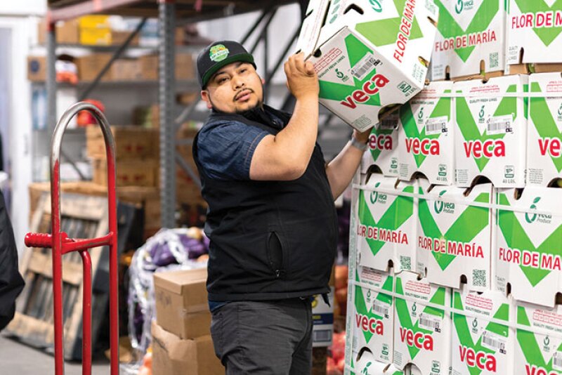 Manuel Orozco, co-owner with his brother, Luis, of Arcadios Produce Inc., fills an order at the company’s facility on the San Francisco Wholesale Produce Market. A multi-year project calls for replacing each of the original four buildings on the market, says Michael Janis, general manager.