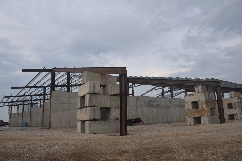A barn being built on a farm. 