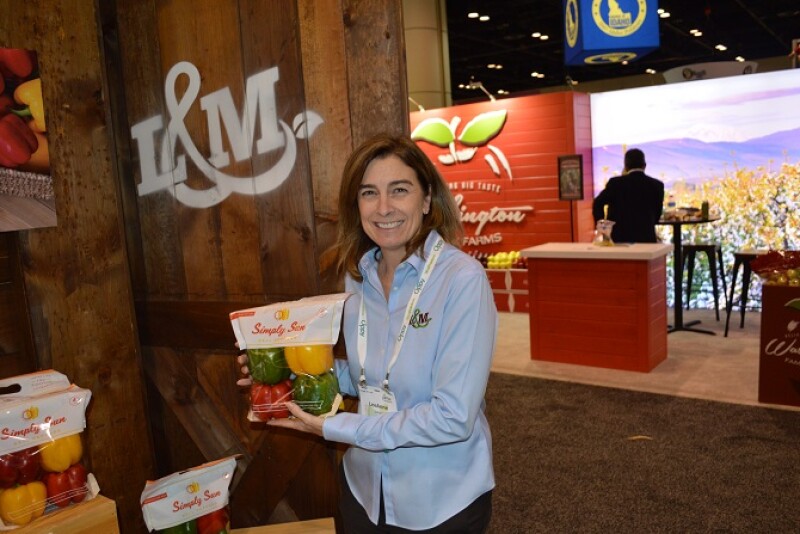  Lee Anne Oxford, director of marketing for L&M Farms, Raleigh, N.C., displays the firm’s Simply Sun Peppers.