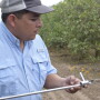 Zach Lopez inspects a soil sample.