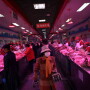 Customer wearing face masks buy pork meat at a wholesale market for agricultural products, as the country is hit by an outbreak of the novel coronavirus, in Beijing, China February 19, 2020. REUTERS/Tingshu Wang