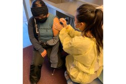 Pictured on the left, Daisy Gonzalez received the COVID-19 Vaccination after her shift.